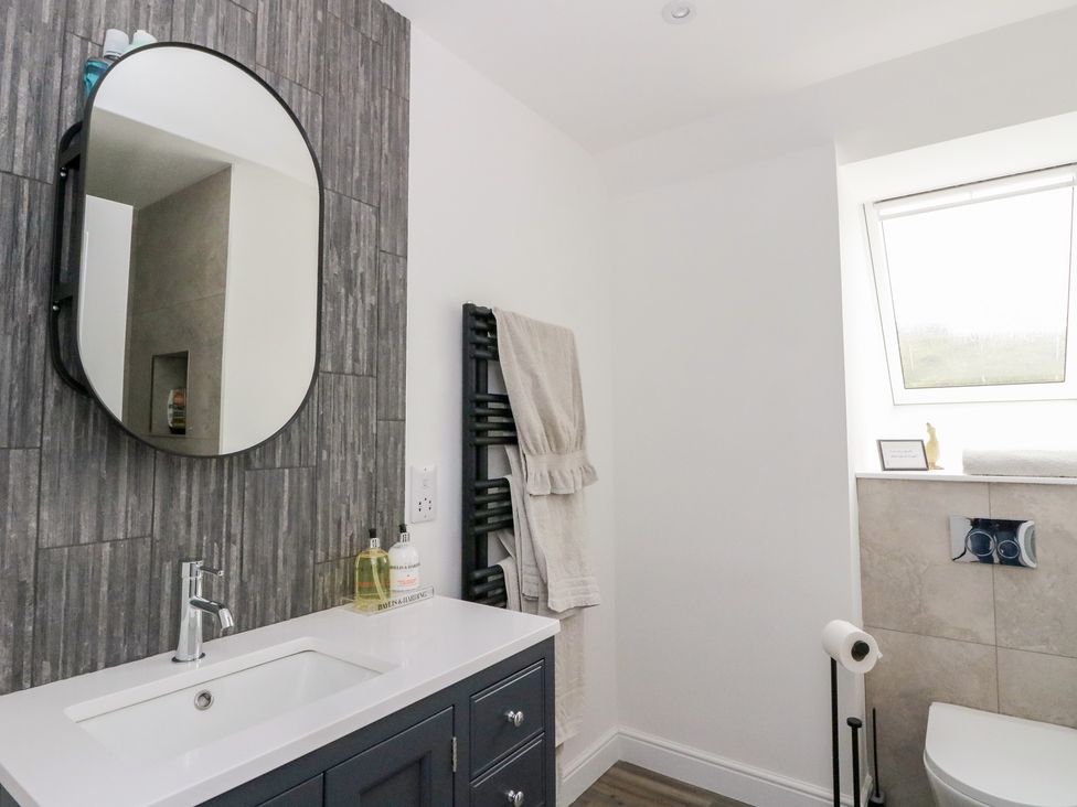 A bathroom with a sink and mirror at Taigh Creag Thulach Taynuilt