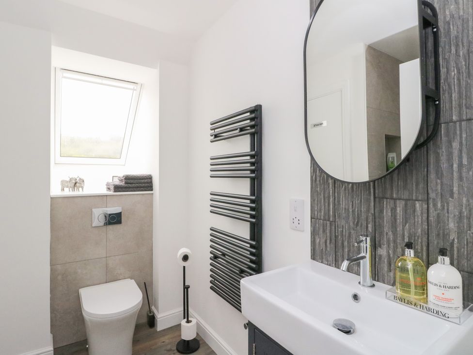 A bathroom with a sink, toilet, and towel rack at Taigh Creag Thulach in Taynuilt