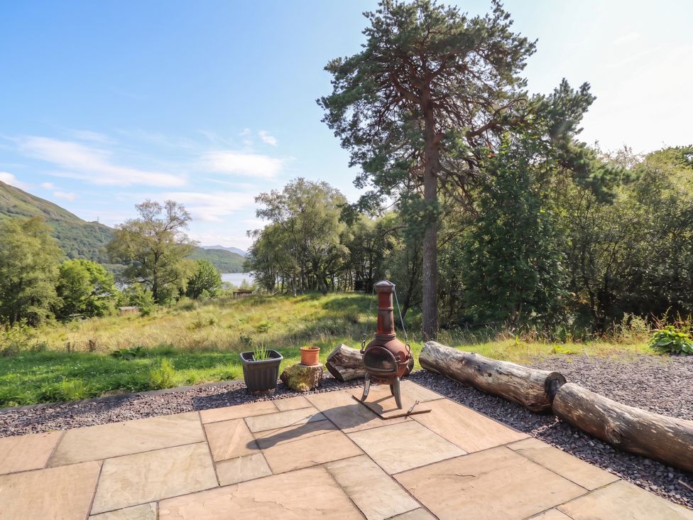 An outdoor area with a chiminea and trees at Taigh Creag Thulach in Taynuilt