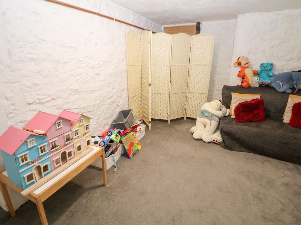 A playroom with toys and a couch at Rock House in Buxton