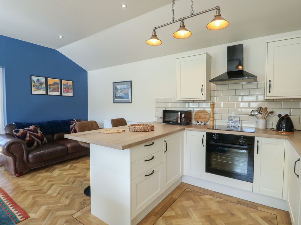A kitchen with a sofa and coffee table at Trillo Lodge in Colwyn Bay