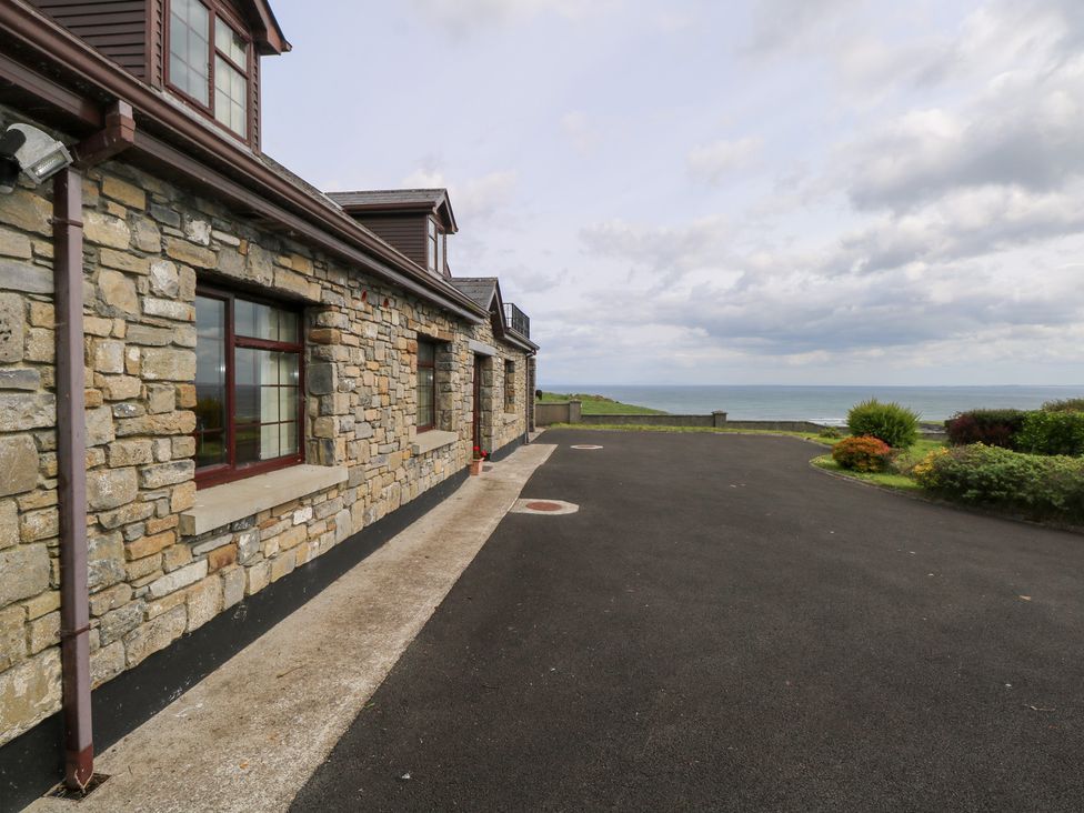 An outdoor area with a stone wall and driveway at Doonalton House, Dromore West, County Sligo