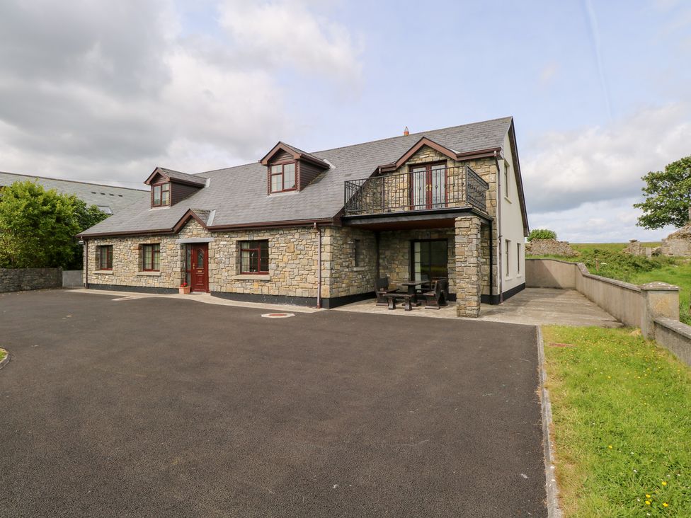 A house with a stone facade and balcony at Doonalton House in Dromore West, County Sligo