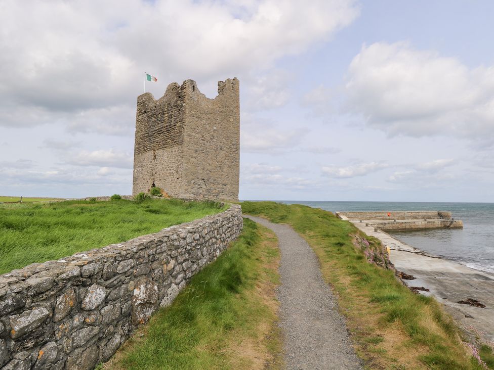 A castle by the sea with a path leading to it at Doonalton House in Dromore West, County Sligo