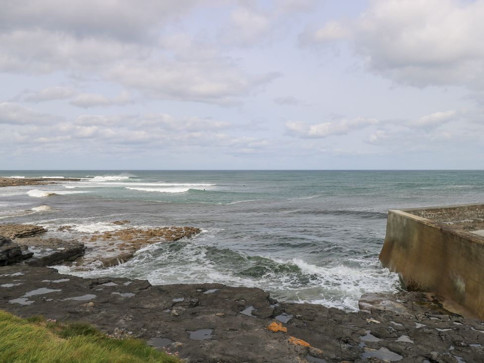 Ocean waves lapping against rocky shore at Doonalton House in Dromore West, County Sligo