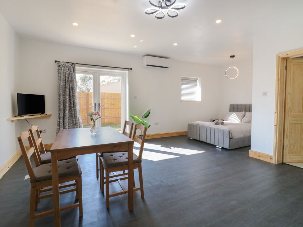 A living room with a dining table and a bed at Annex Studio 1 Northampton