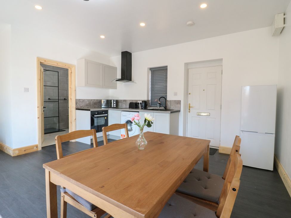 A kitchen with a table and chairs and appliances at Annex Studio 1 Northampton