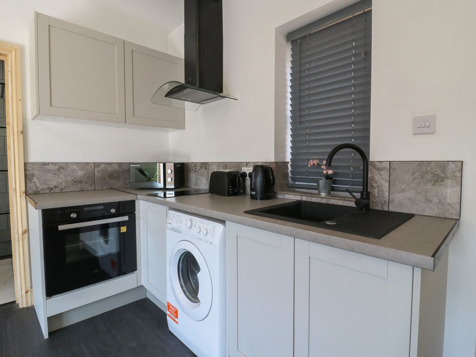 A kitchen with appliances and a sink at Annex Studio 1 Northampton