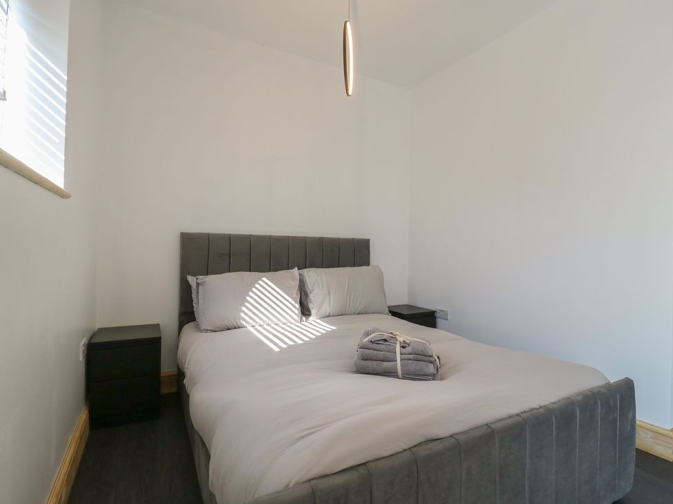 A bedroom with a bed and bedside table at Annex Studio 1 Northampton