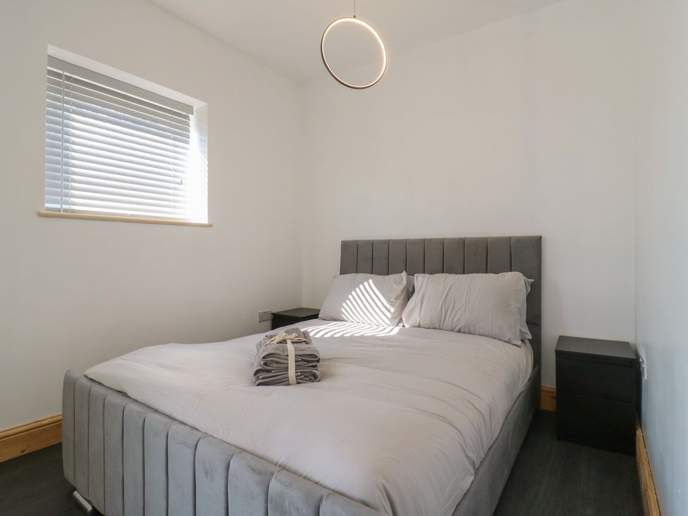 A bedroom with a bed and bedside table at Annex Studio 1 Northampton