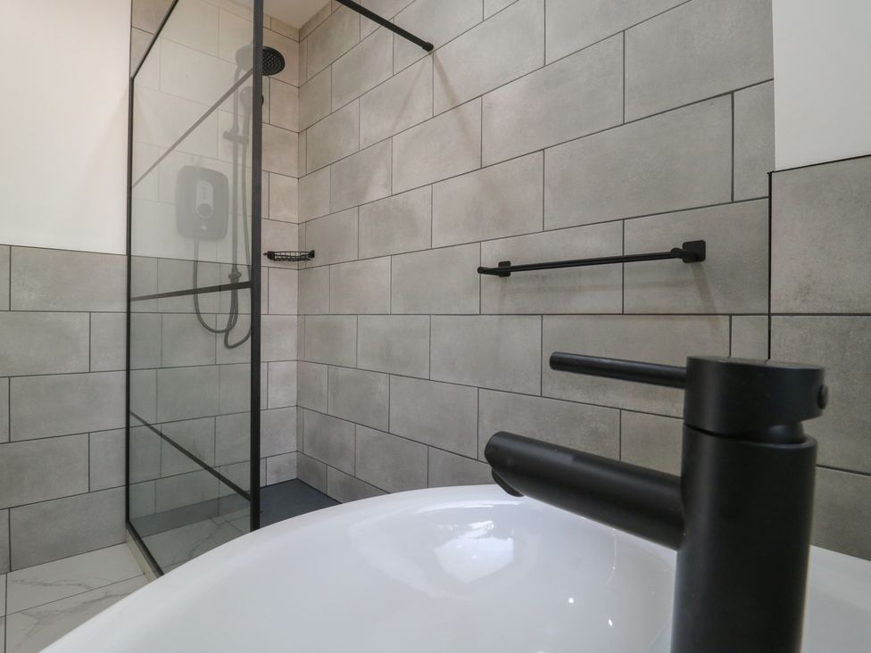 A bathroom with a shower and bath tub at Annex Studio 1 Northampton