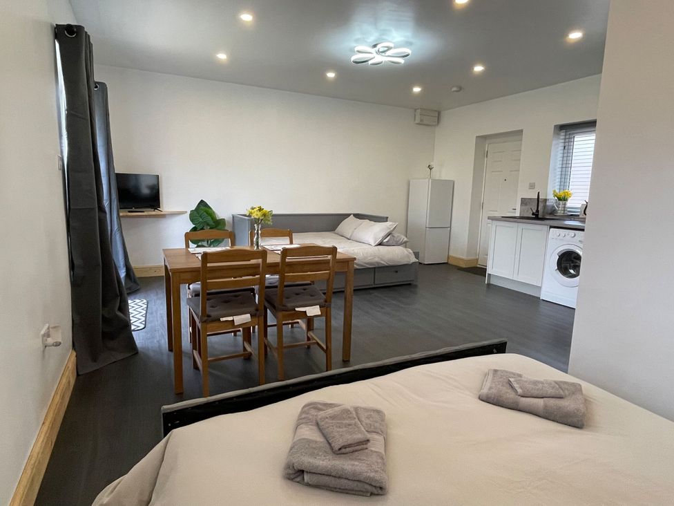 A studio with beds and dining table at Daisy Hannington near Northampton
