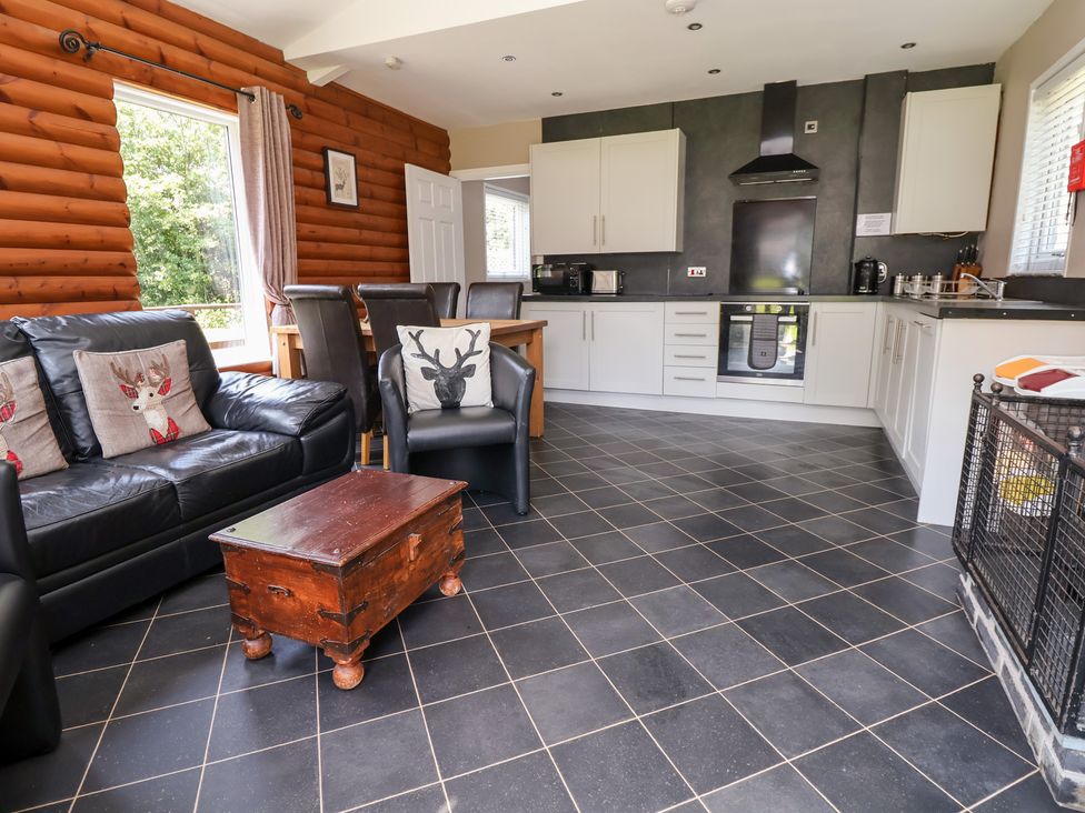 A kitchen with dining area and sofa at The Fallows in Llanerch Park near St Asaph