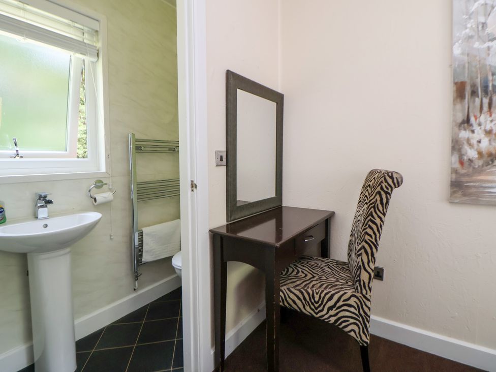 A bathroom with a sink and vanity area at The Fallows Llanerch Park near St Asaph