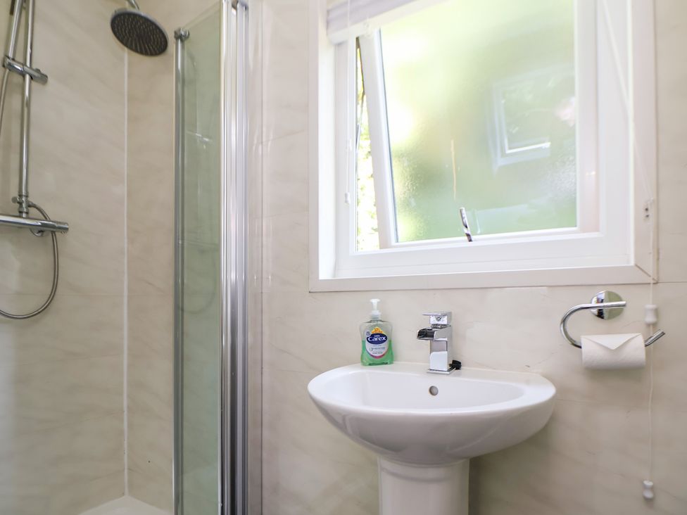 A bathroom with a shower and sink at The Fallows in Llanerch Park near St Asaph