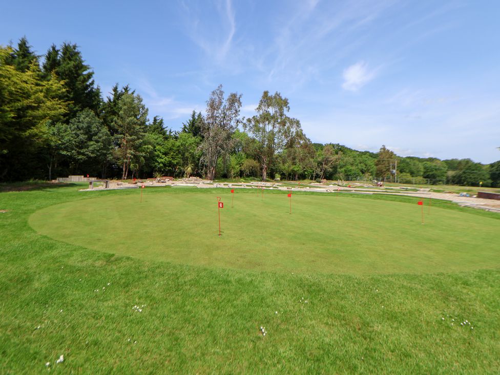 A golf putting green with flags at The Fallows in Llanerch Park near St Asaph