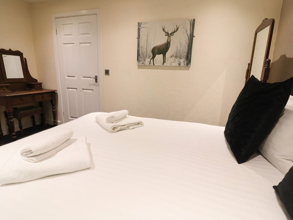 A bedroom with a bed and mirror at The Roe Llanerch Park near St Asaph