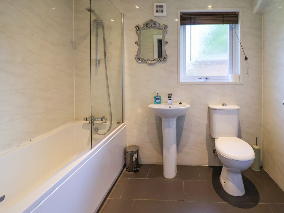 A bathroom with bathtub, sink, and toilet at The Roe in Llanerch Park near St Asaph