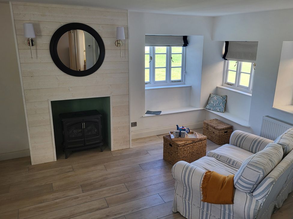 A living room with a sofa and coffee table at Fishermans Locker in West Bay