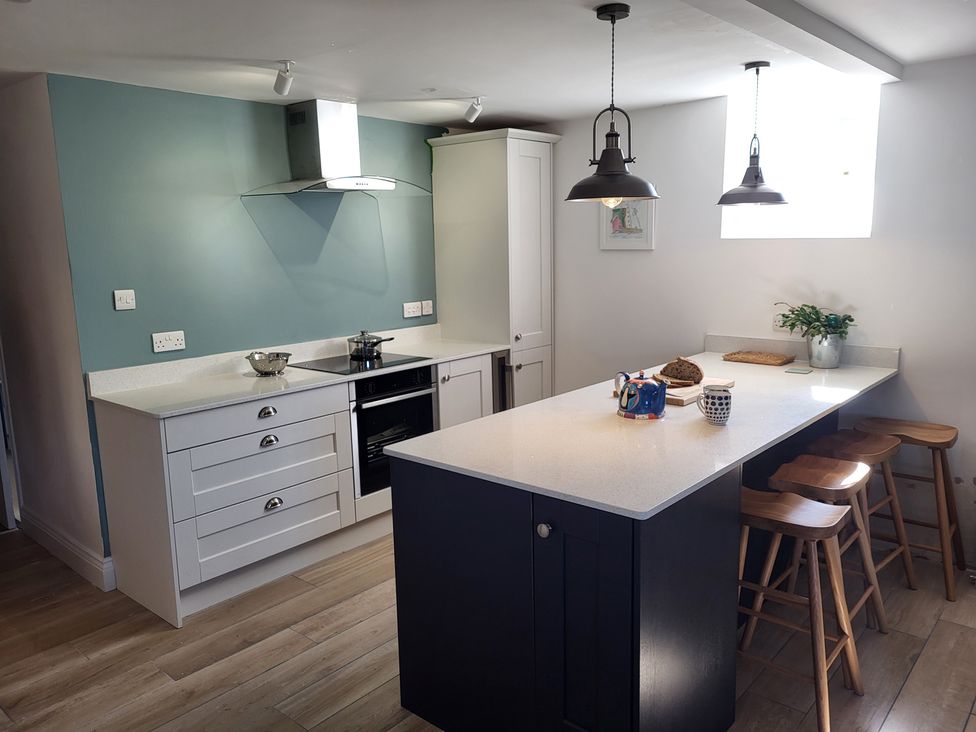 A kitchen with appliances and an island at Fishermans Locker in West Bay