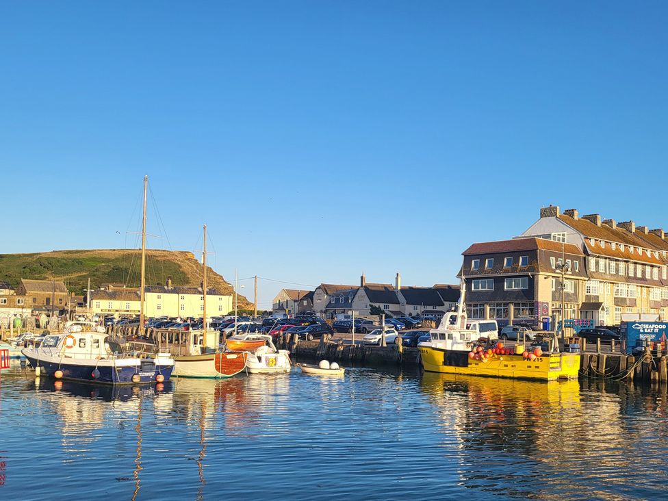 A harbor with boats and buildings at Fishermans Locker in West Bay