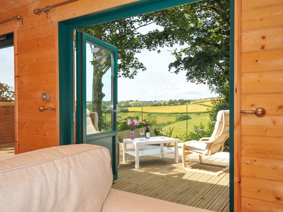 A seating area with a view of outdoor landscape at Owl Lodge Menheniot