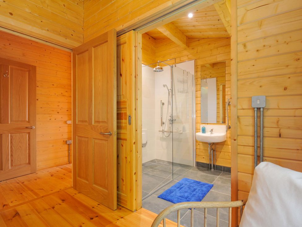 A bathroom with a shower and sink at Owl Lodge Menheniot