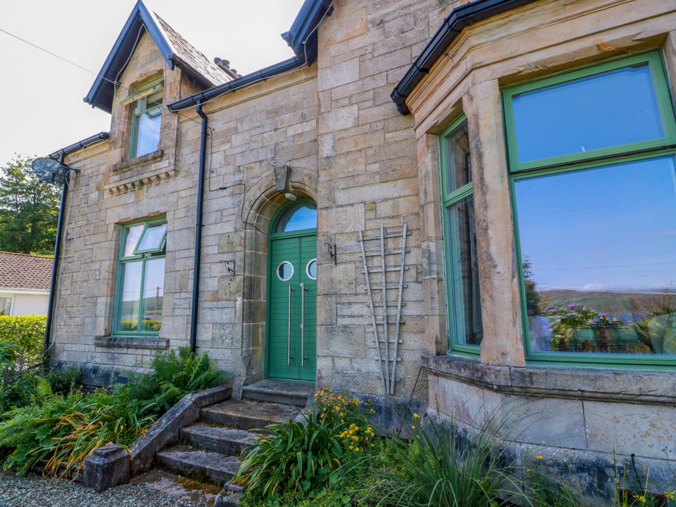 A house exterior with green door and windows at Altafearn in Tighnabruaich