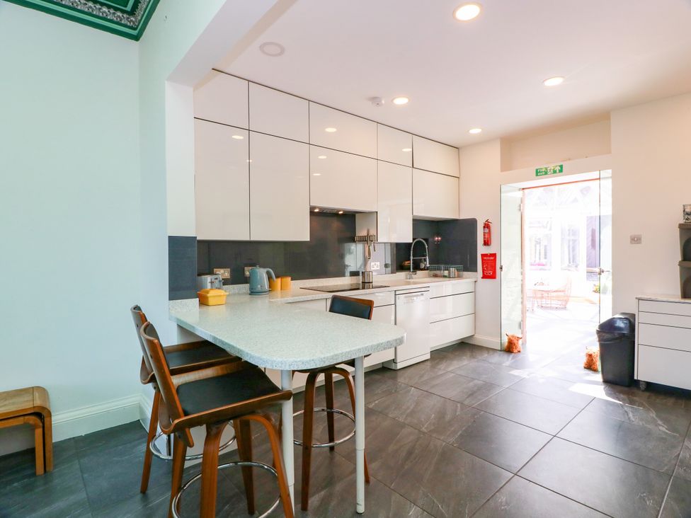 A kitchen with countertop and stools at Altafearn in Tighnabruaich
