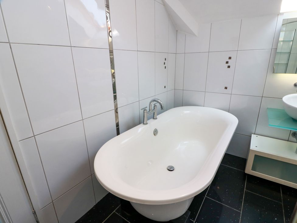 A bathroom with a bathtub and sink at Altafearn in Tighnabruaich