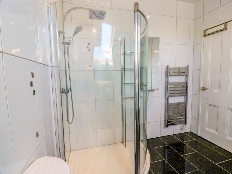 A bathroom with a shower and towel rail at Altafearn in Tighnabruaich
