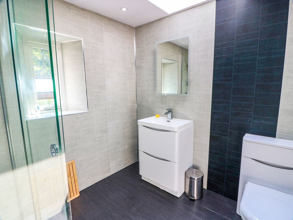 A bathroom with a shower, sink, and toilet at Altafearn in Tighnabruaich
