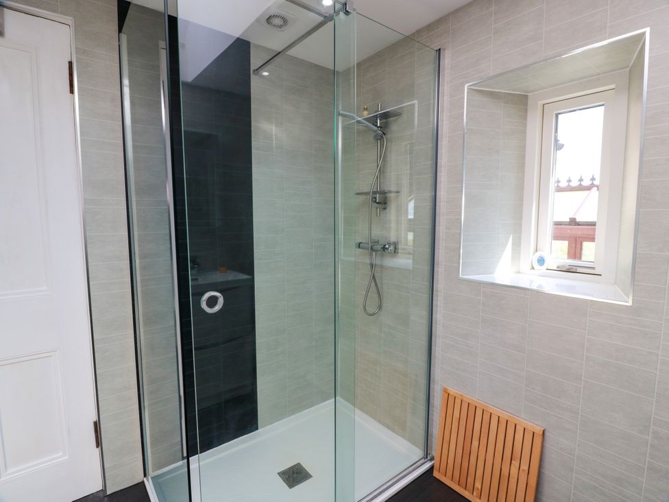 A shower with glass enclosure in a bathroom at Altafearn in Tighnabruaich