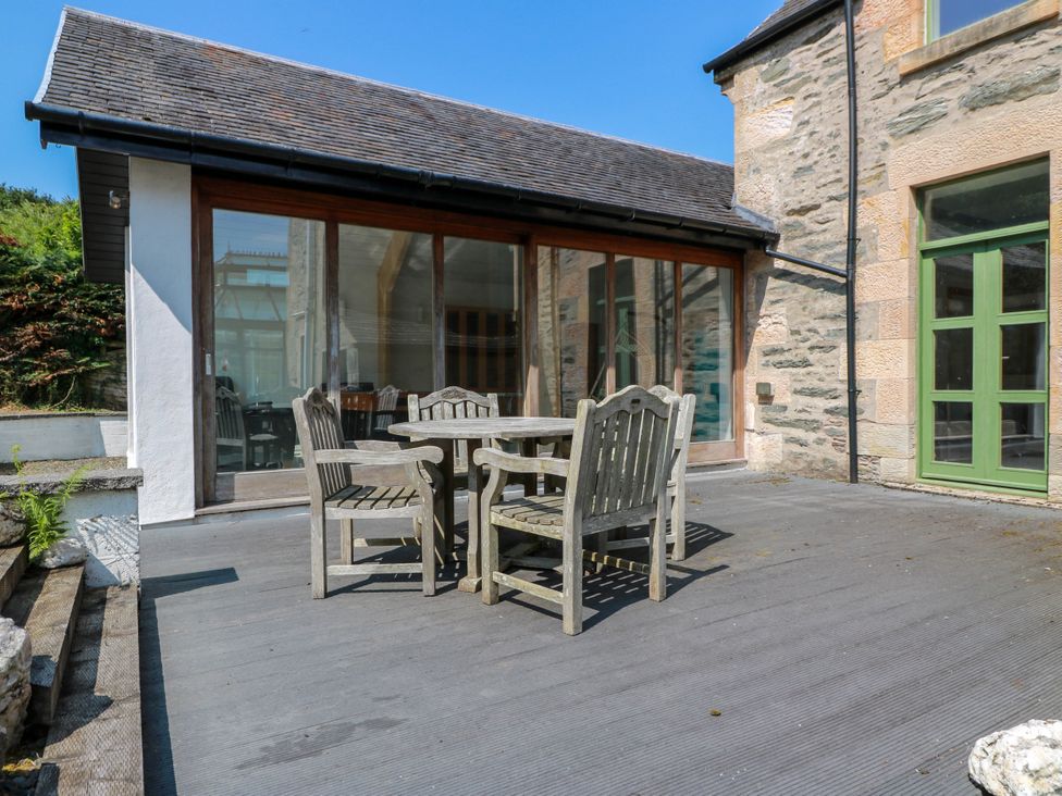 An outdoor seating area with a table and chairs at Altafearn in Tighnabruaich