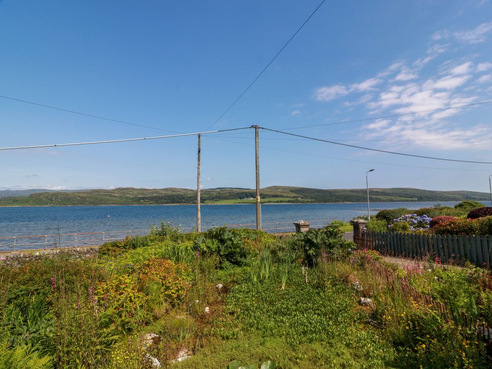 A view of water and greenery from a garden at Altafearn in Tighnabruaich