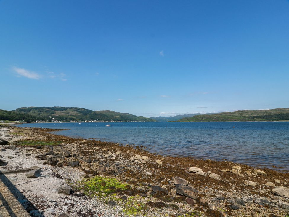 A beach with rocks and water at Altafearn in Tighnabruaich