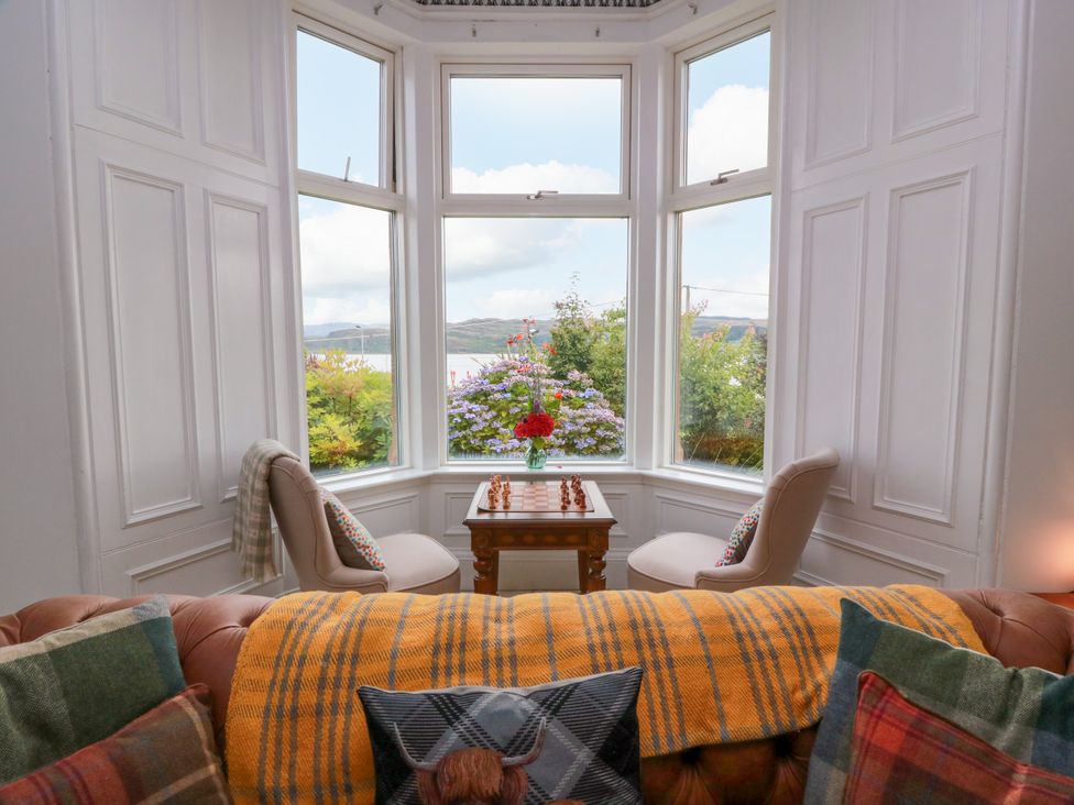 A living room with a chess set on a table at Altafearn in Kames