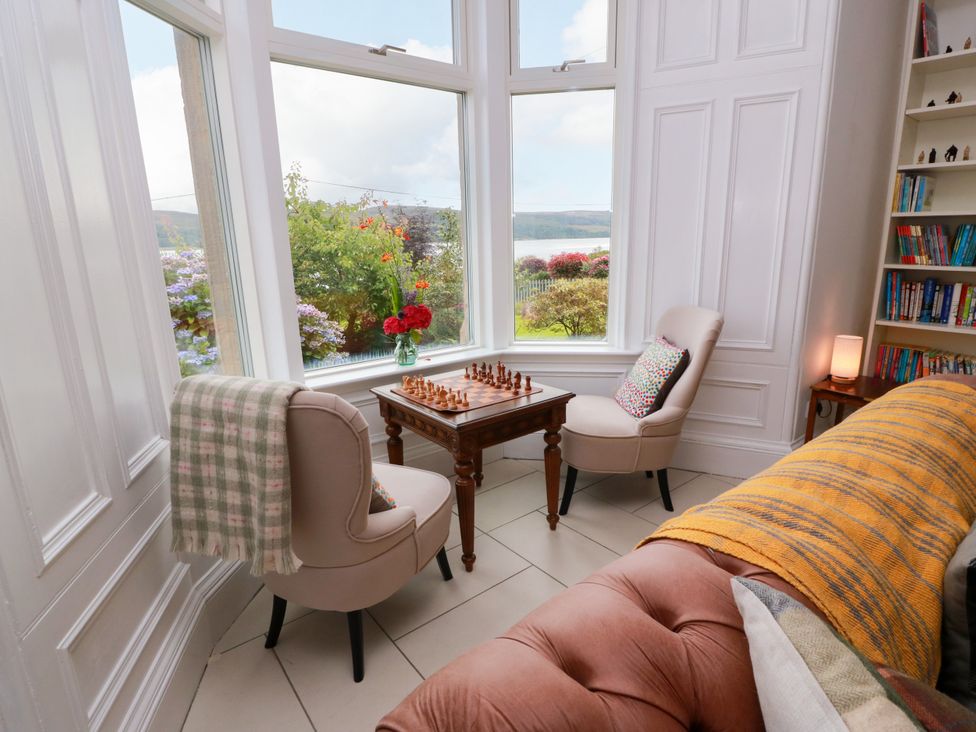 A sitting room with a chess set and armchairs at Altafearn in Kames