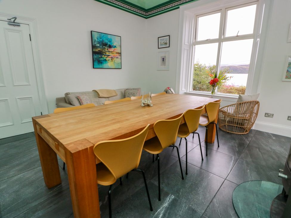 A dining room with a table and chairs at Altafearn in Kames
