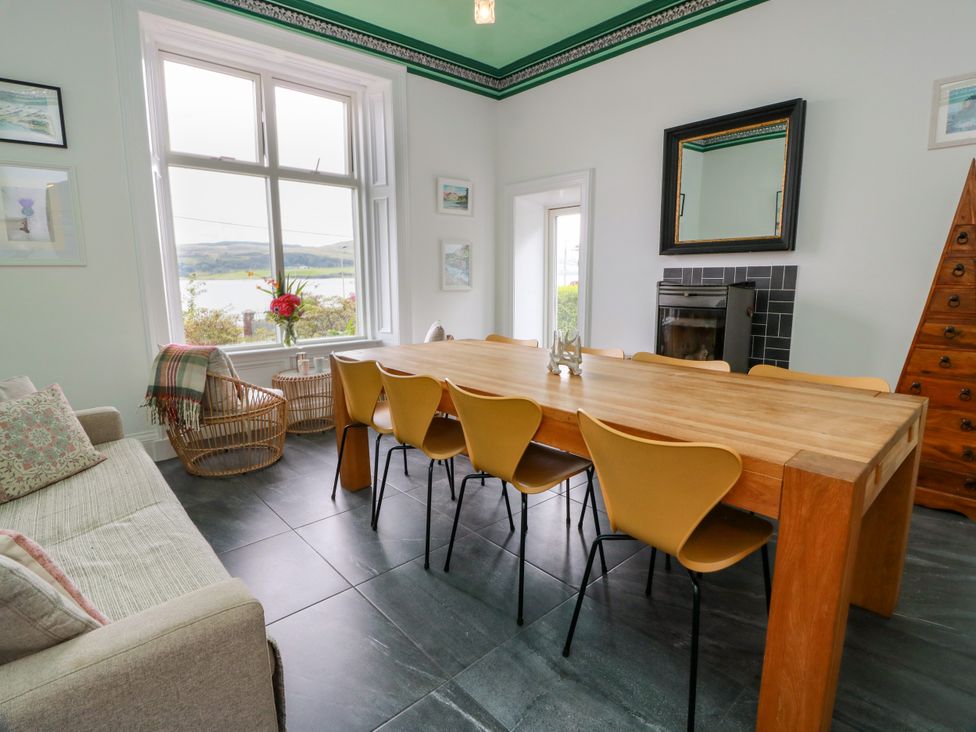 A dining room with a table and chairs at Altafearn in Kames