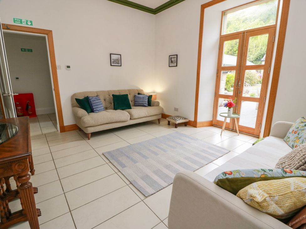 A living room with sofas and a side table at Altafearn in Kames