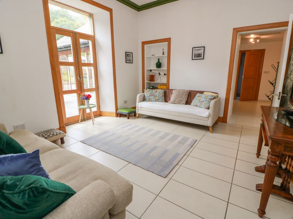 A living room with a sofa and table at Altafearn in Kames