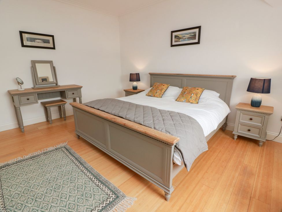 A bedroom with a bed and desk at Altafearn in Kames