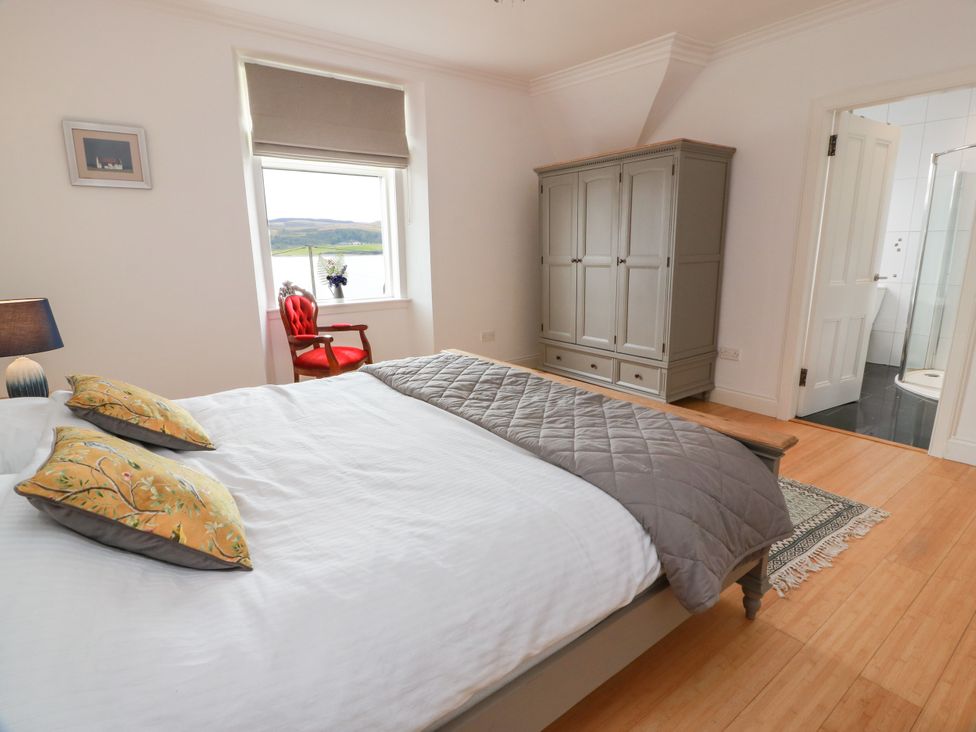 A bedroom with a bed and wardrobe at Altafearn in Kames