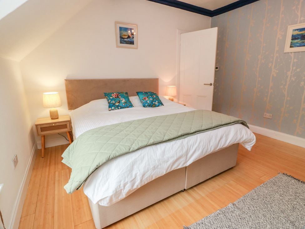 A bedroom with a bed and lamp at Altafearn in Kames