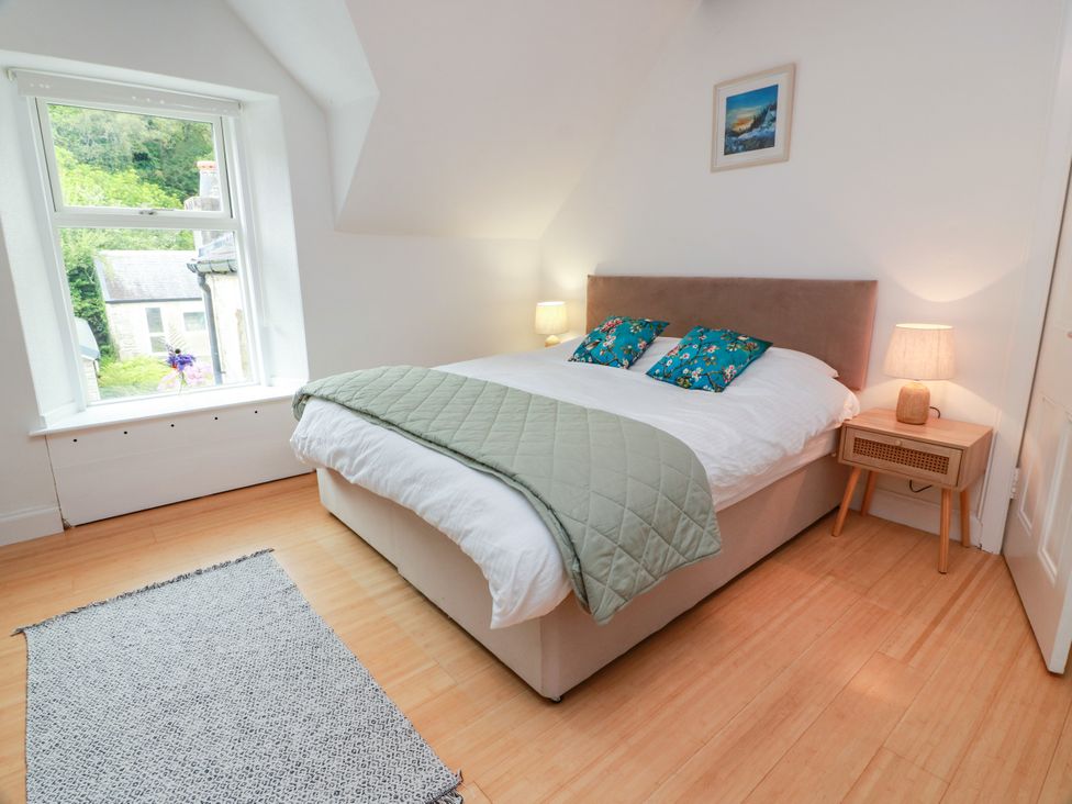 A bedroom with a bed and a nightstand at Altafearn in Kames