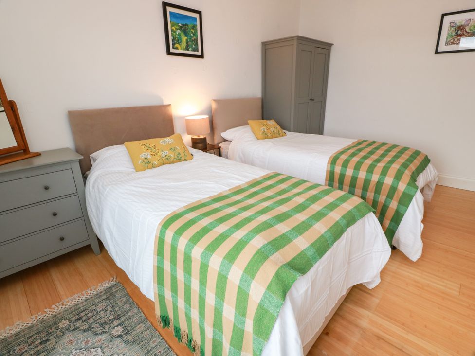 A bedroom with two beds and a dresser at Altafearn in Kames
