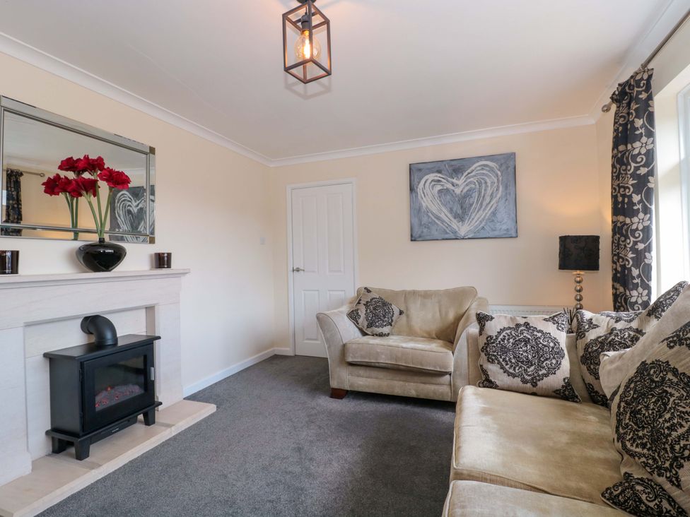 A living room with a sofa and fireplace at No 8 in Burnham-on-Sea