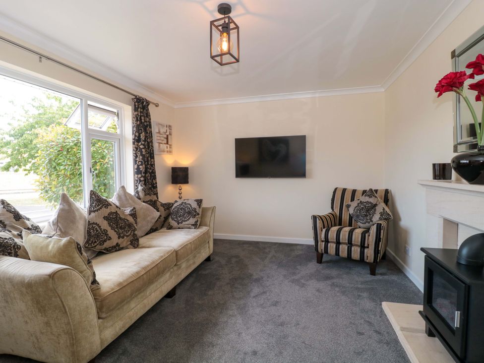 A living room with a sofa and television at No 8 Burnham-on-Sea