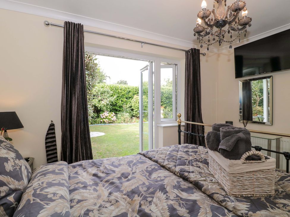 A bedroom with a bed and garden view at No 8 in Burnham-on-Sea